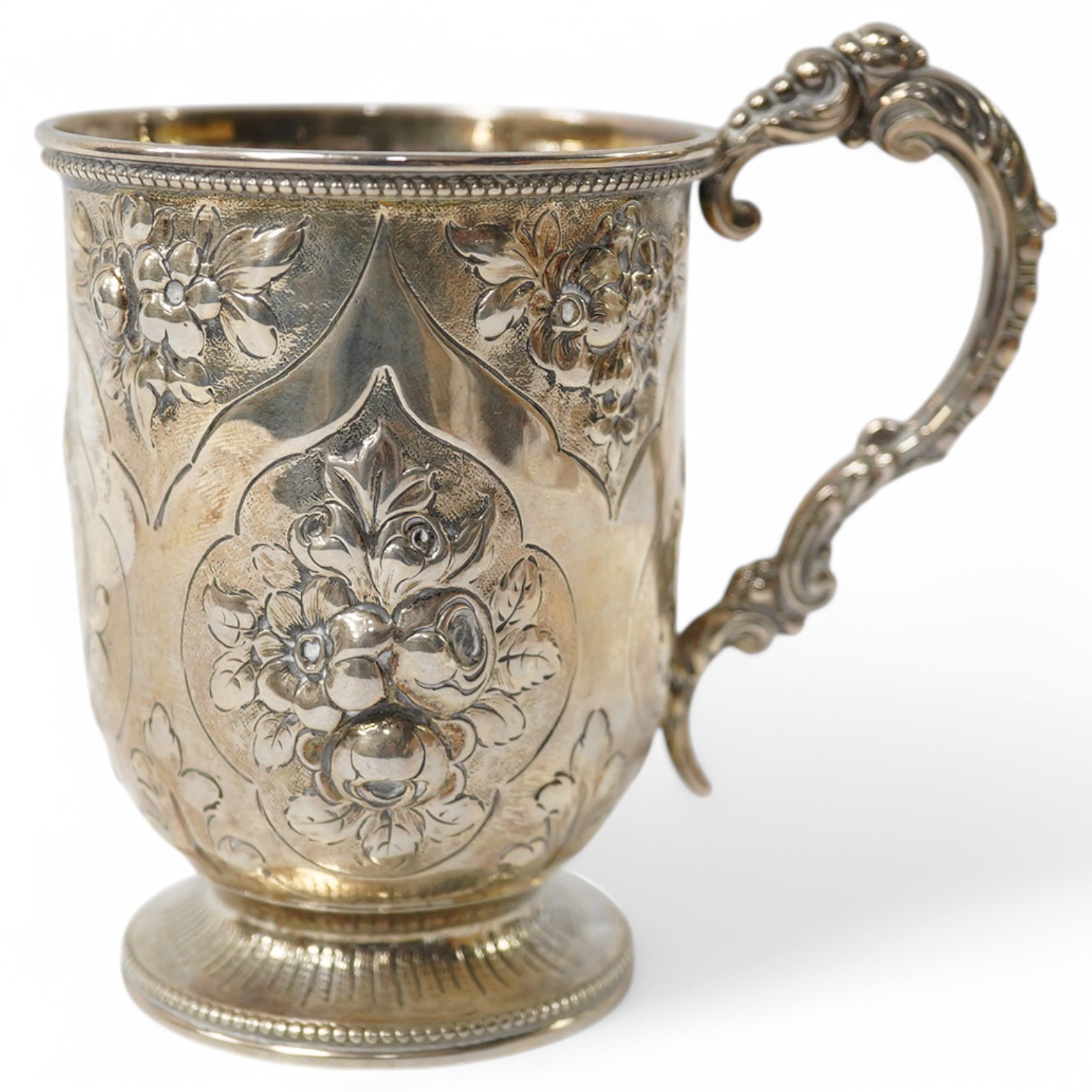 A Victorian embossed silver christening mug, George Adams, London, 1868, with later engraved monogram with date, 10.5cm, 4.5oz. Condition - fair to good